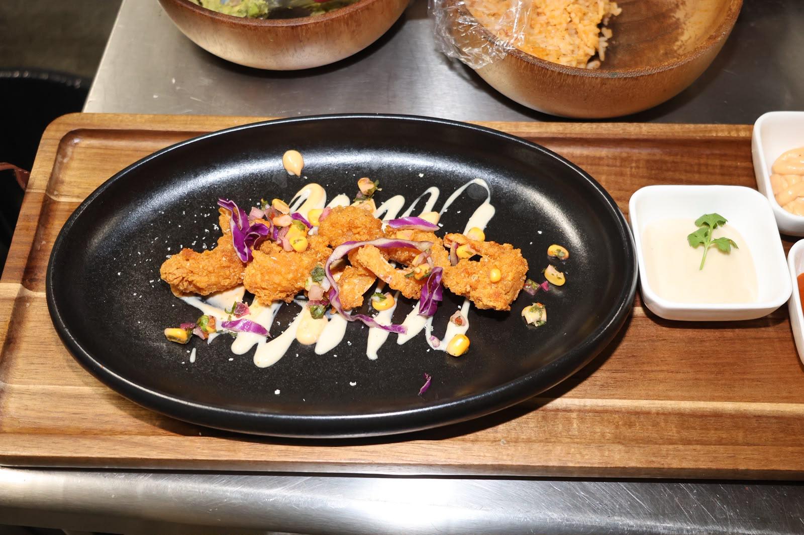 Crispy chicken bites served at Illumina Bar